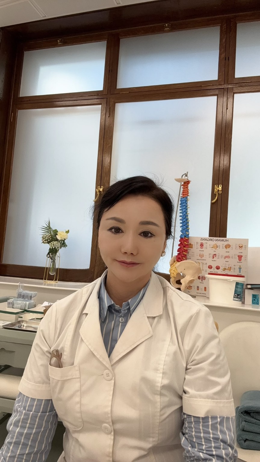 Dr Anna in a clinic wearing a white coat